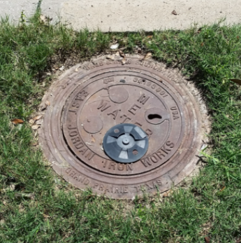 Water meter lid in grass